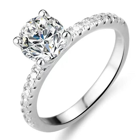 Silver ring with moissanite, jewelry box, GRA certificate, and silver polishing cloth on a white background